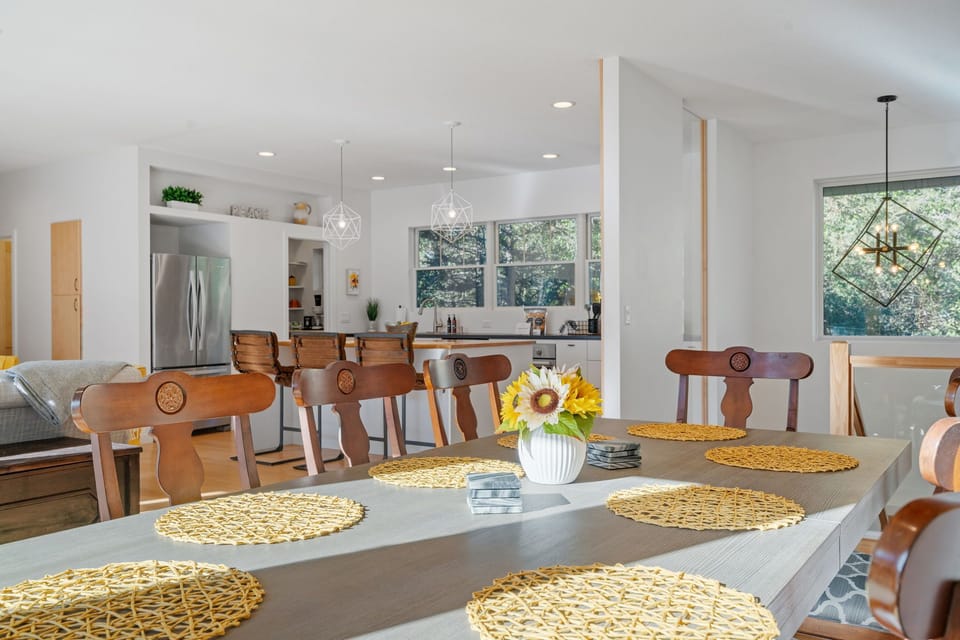 Gather around this stunning dining table where natural light streams through large windows, creating the perfect setting for memorable meals with loved ones.