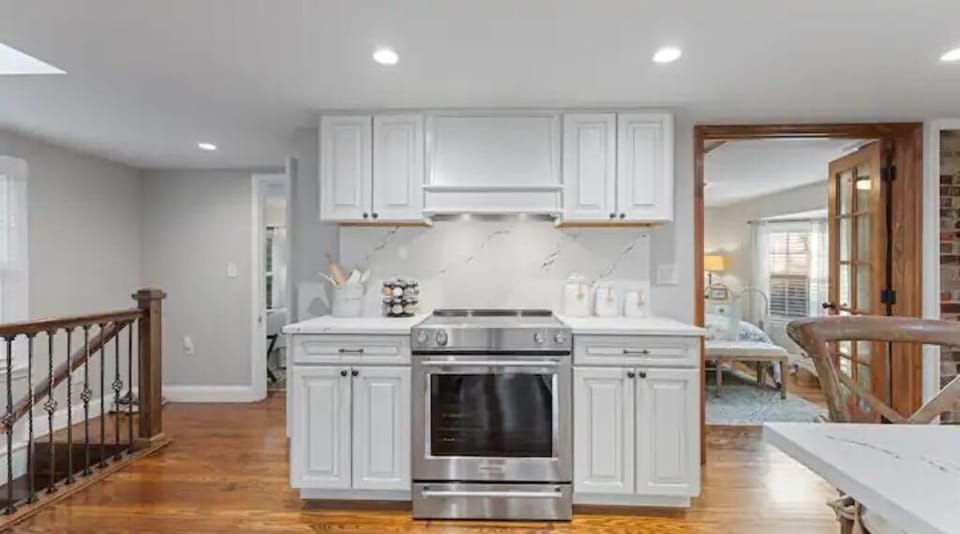 KitchenAid range with Cambria quartz tops and full height backsplash.