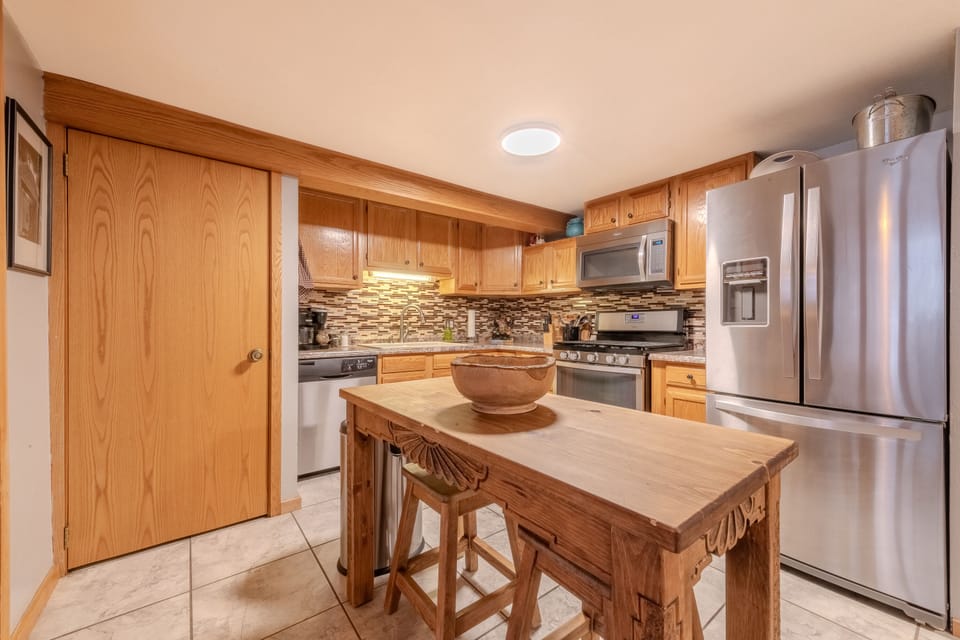 Full kitchen with stacked washer and dryer behind the door. 