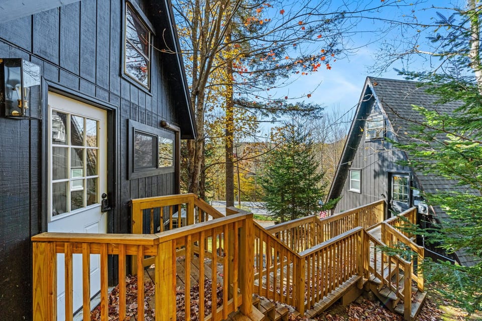 View of the outside with the bunk house on the left and the main A-frame house on the right.