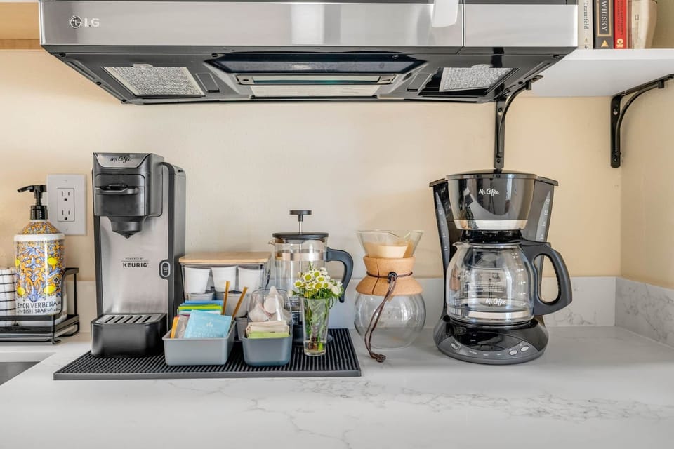 This fully stocked coffee and tea station includes a single‑serve Keurig, classic drip coffee maker,