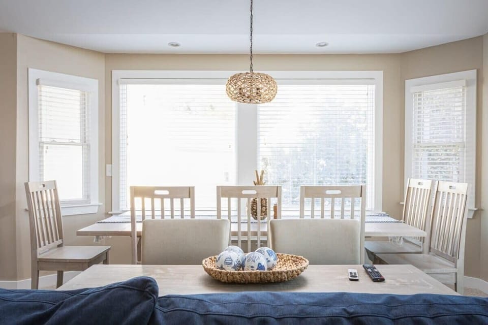Top level: Dining Area featuring a large, farmhouse-style table with seating for the entire family