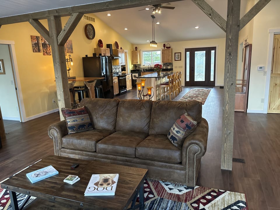 Living room with Dish tv and open to kitchen. 