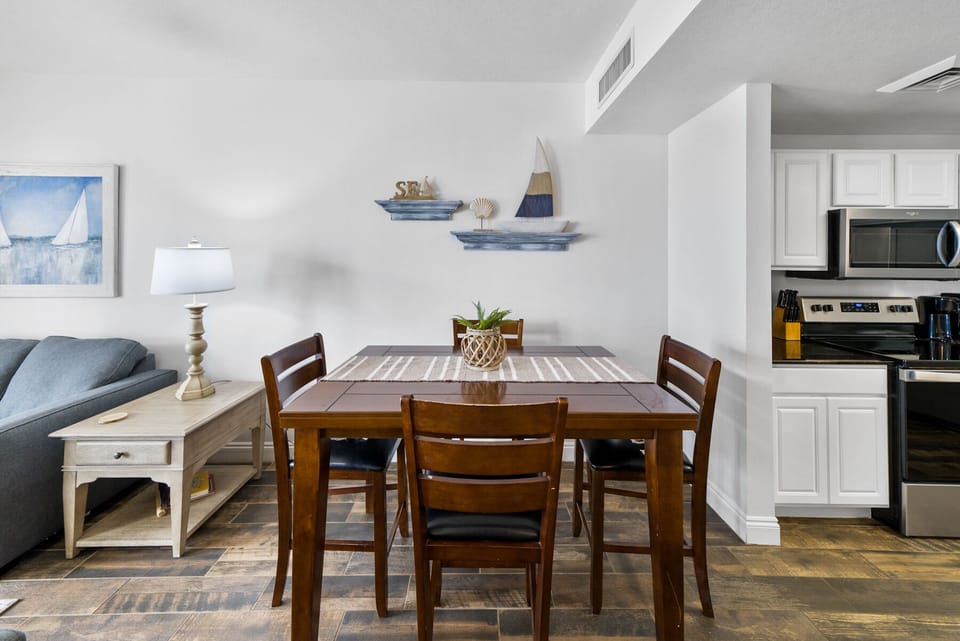Gather around this inviting dining table where you'll enjoy meals with loved ones in your bright, open-plan space featuring a fully equipped kitchen.