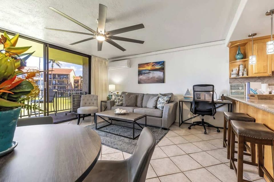 Living room features a split AC, smart TV w/cable, "Big Ass Fan"(that's really the name), queen sofa sleeper, office desk to get some work done,  bar stools, & dining table.