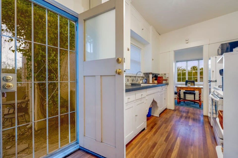 Back door from kitchen leads to small porch with seating, perfect for morning coffee/tea or evening wine/cocktail
