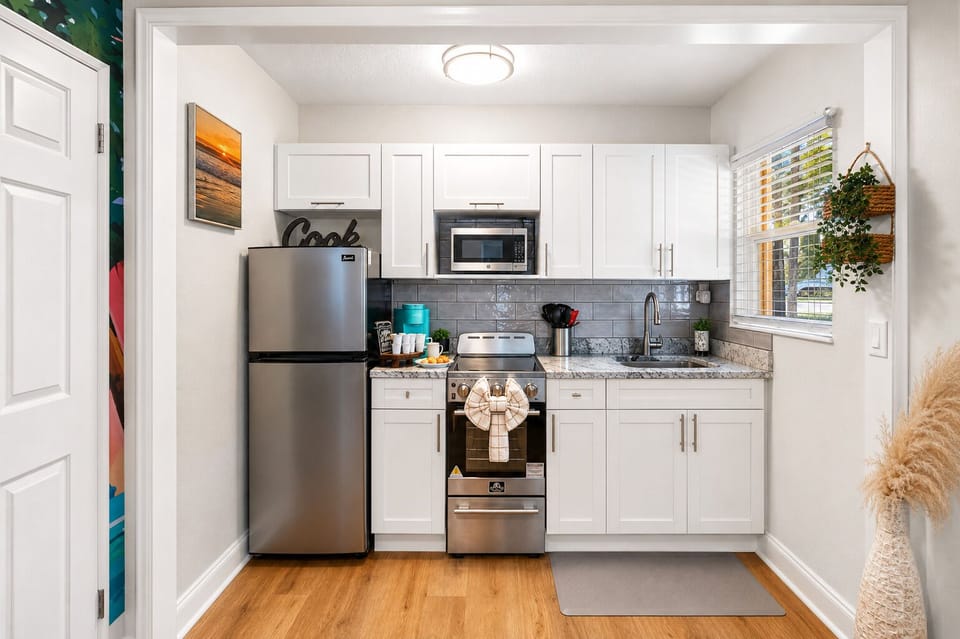 Cook with ease in the modern kitchen featuring full-size appliances, cookware, ample counter space, and everything you need for a comfortable stay.