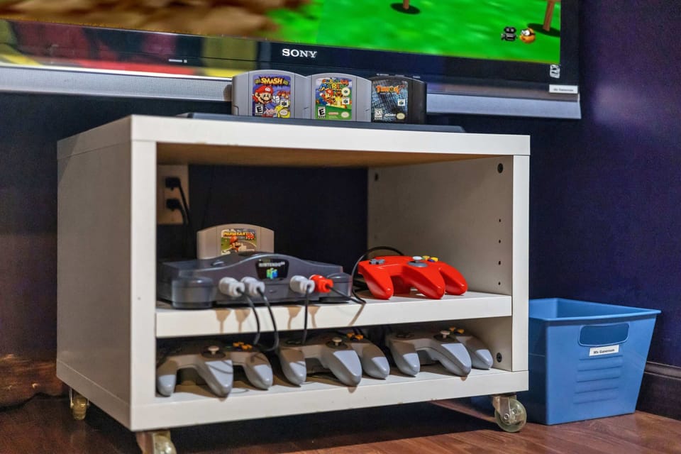 Grab the N64 controller for Mario Kart or Smash Bros — the cartridges are already lined up and ready for you.