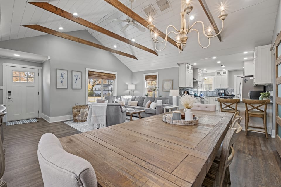 Spacious dining area with vaulted ceilings and exposed beams, offering an open flow into the living room and kitchen at Mission Outlook in Mission, KS.