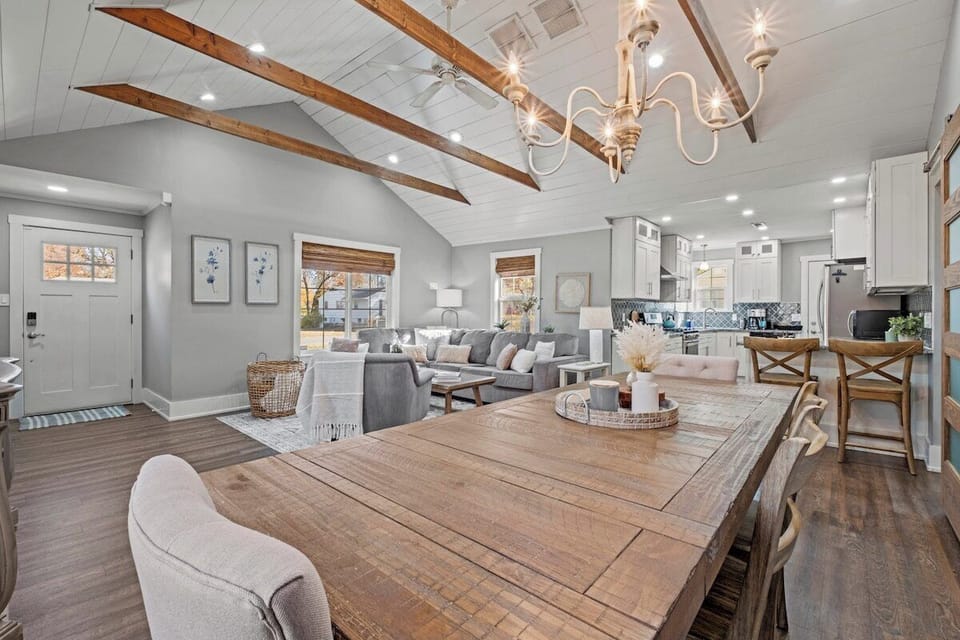 Spacious dining area with vaulted ceilings and exposed beams, offering an open flow into the living room and kitchen at Mission Outlook in Mission, KS.