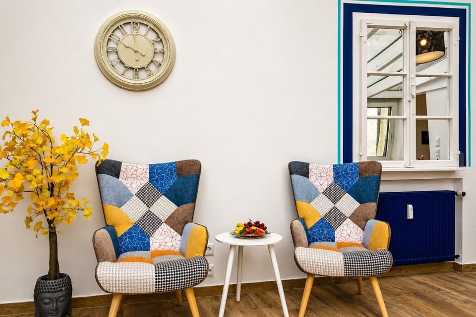 A welcoming lounge corner with comfortable accent chairs and elegant touches creates the perfect spot to relax, chat, or plan your next adventure.