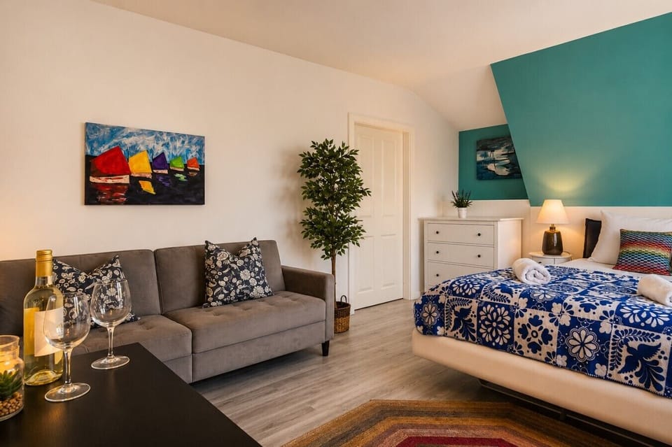 Enjoy a spacious bedroom with comfortable bedding, a relaxing seating area, and contemporary furnishings that create a welcoming home-away-from-home atmosphere.