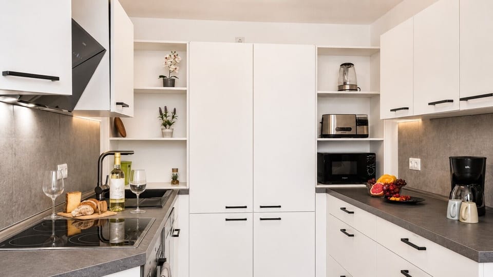 Enjoy the convenience of a spacious, well-stocked kitchen featuring cooking essentials, modern appliances, and plenty of room for meal preparation.