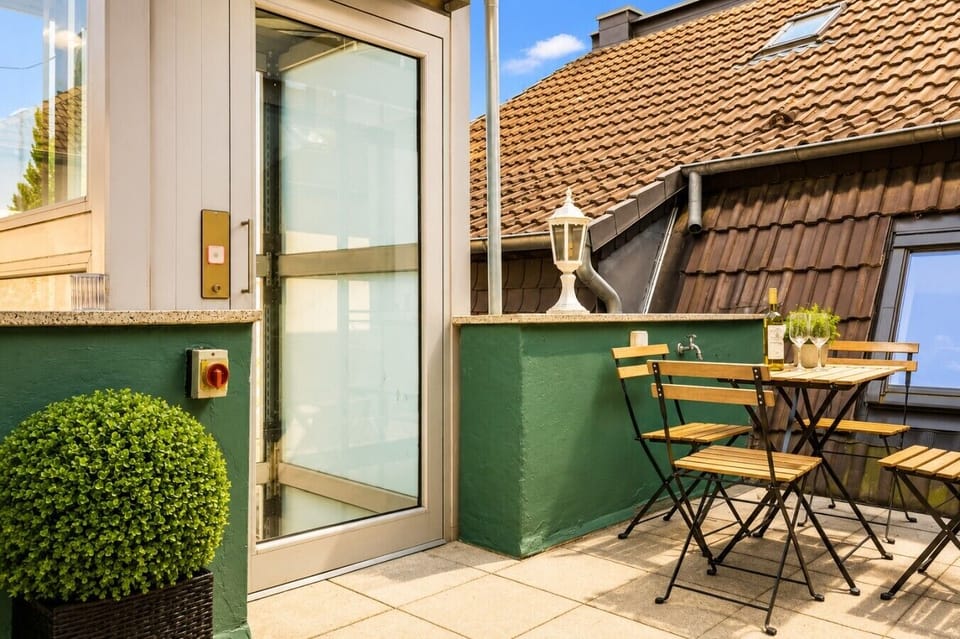 Unwind on the cozy balcony featuring a bistro table, comfortable seating, and a peaceful outdoor setting ideal for breakfast or evening drinks
