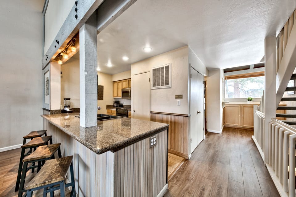 Gather around your spacious granite breakfast bar while morning light streams through windows, creating the perfect space for coffee and conversation.
