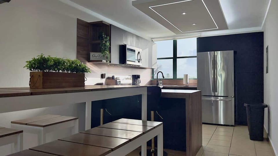 Dinning area is composed of a dinning table for 4 guests and a counter-top with 2 stools to accommodate up to 6 guests.