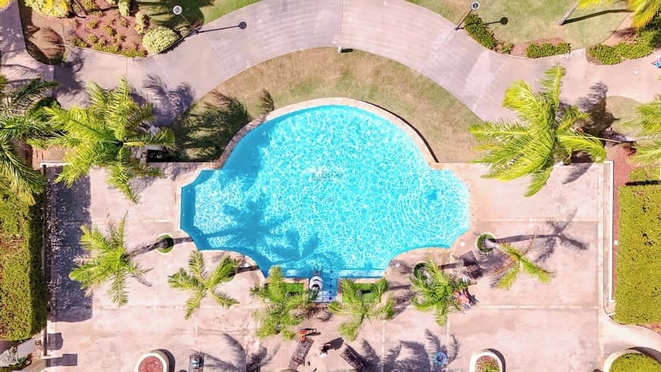 Enjoy the heated pool with all of the tropical grounds around you.