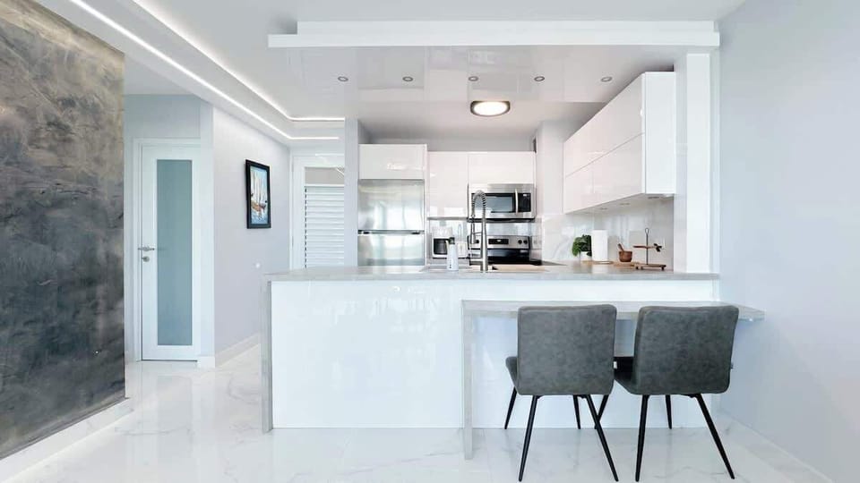 The kitchen also features an attached countertop with stools to enjoy coffee and brunch.