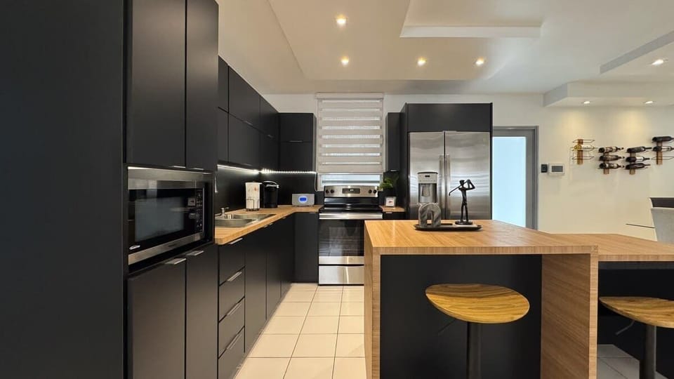 Fully equipped kitchen with island and stools. 