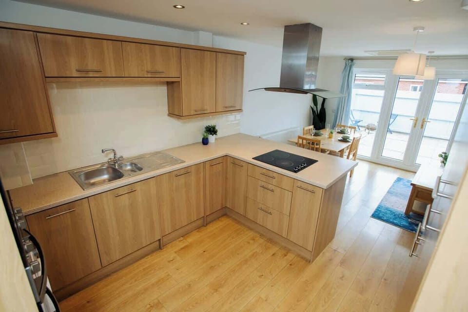 A sleek and spotless kitchen equipped with all essential amenities and a convenient washing machine-where functionality meets modern simplicity for effortless living.