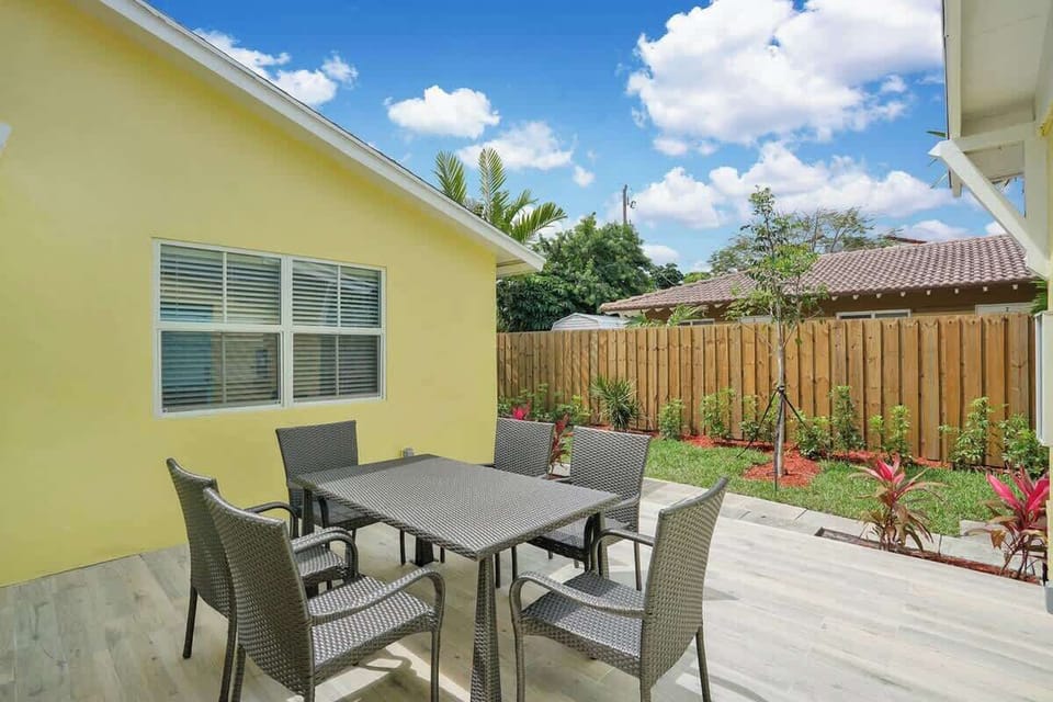 Fenced backyard patio with outdoor dining set