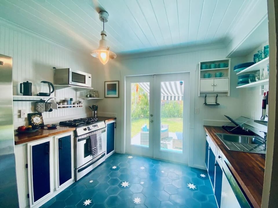 Full-size kitchen with gas stove that opens onto back yard