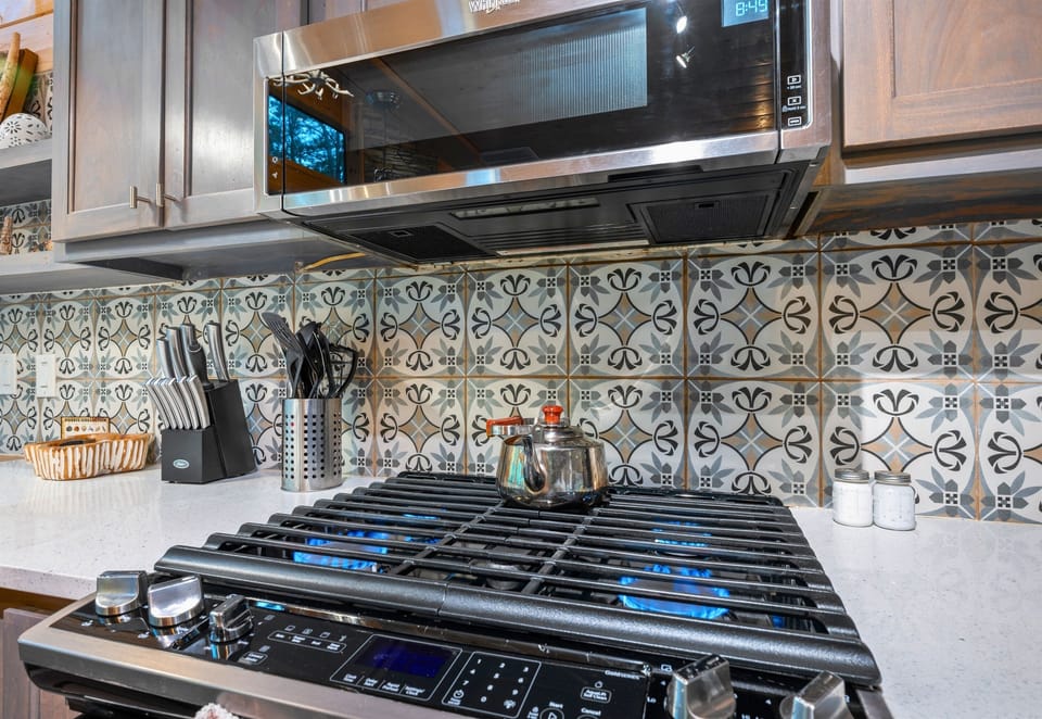 The cooktop and detailed backsplash add a bit of personality while still keeping the space clean and practical.