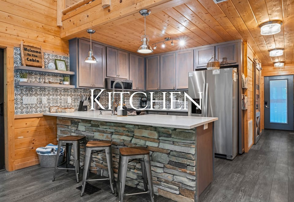 The kitchen blends rustic cabin charm with modern convenience, giving you everything you need for cooking and entertaining.