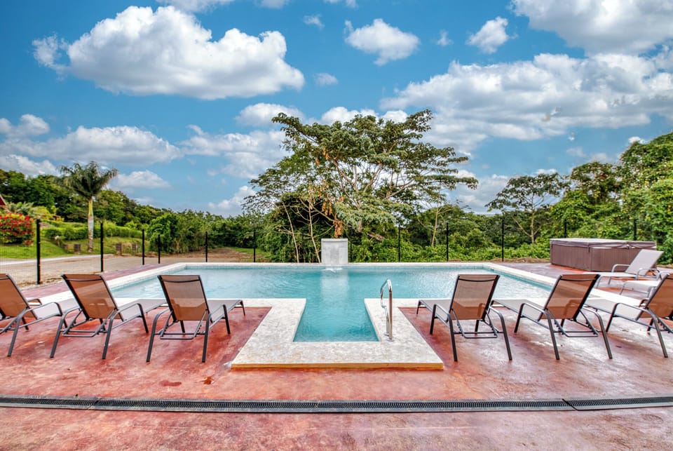 Outdoor Oasis: Dive into relaxation by the shimmering community pool, surrounded by lush greenery and sunshine!