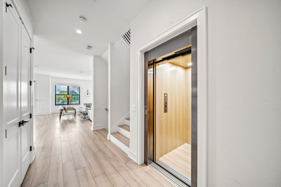 The main floor hall with the main floor living space. Main floor bedrooms are behind.