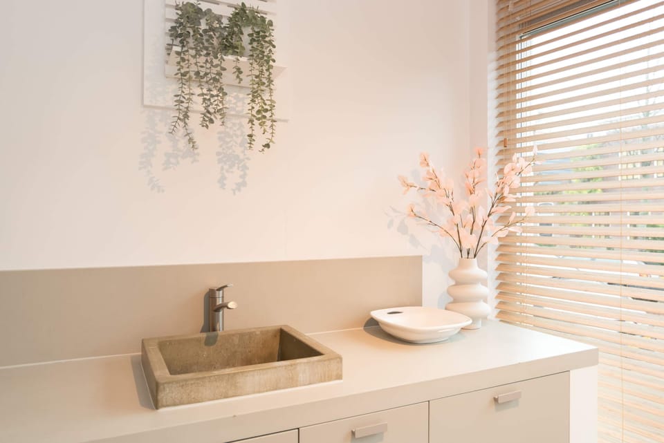 Minimalist kitchen equipped with sink and modern essentials 

