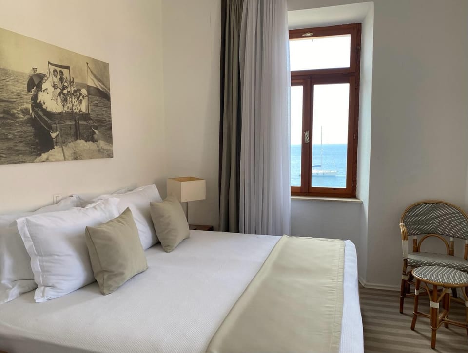 Standard Double Room, Sea View | 1 bedroom, in-room safe, desk, iron/ironing board