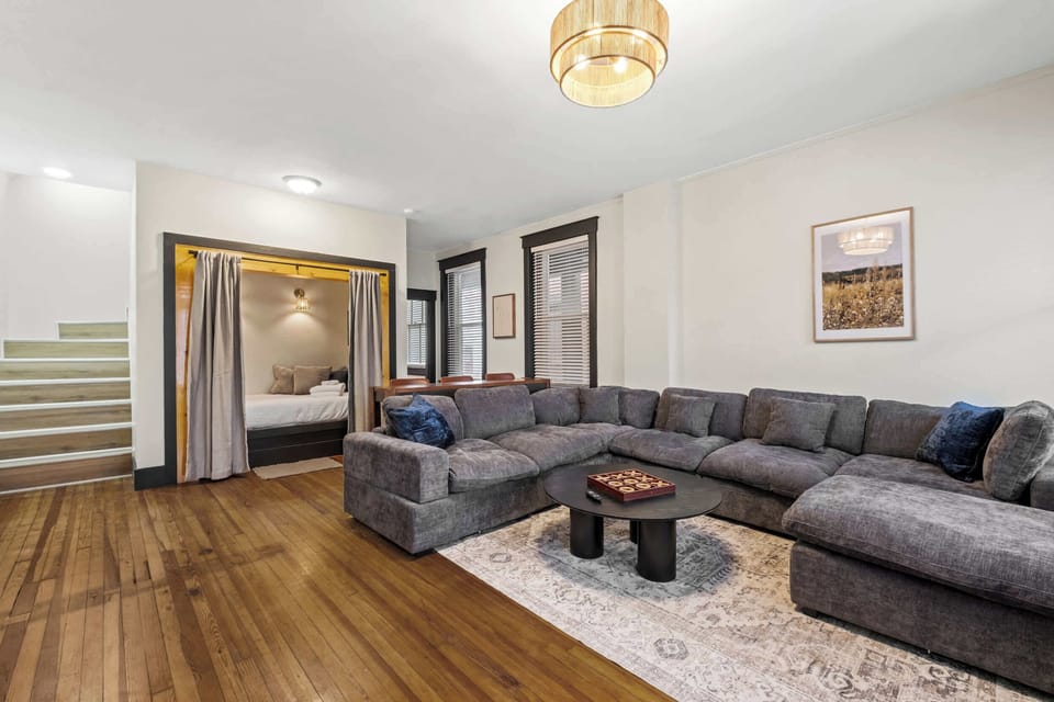 Living Room: Relax in our bright living space, featuring a comfy sofa, wooden floors, and plenty of natural light to make you feel right at home.