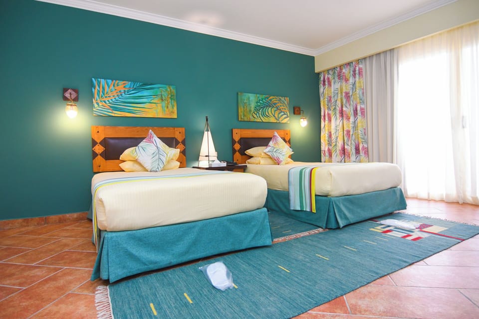 Deluxe Double or Twin Room, Sea View | Minibar, in-room safe, desk, bed sheets