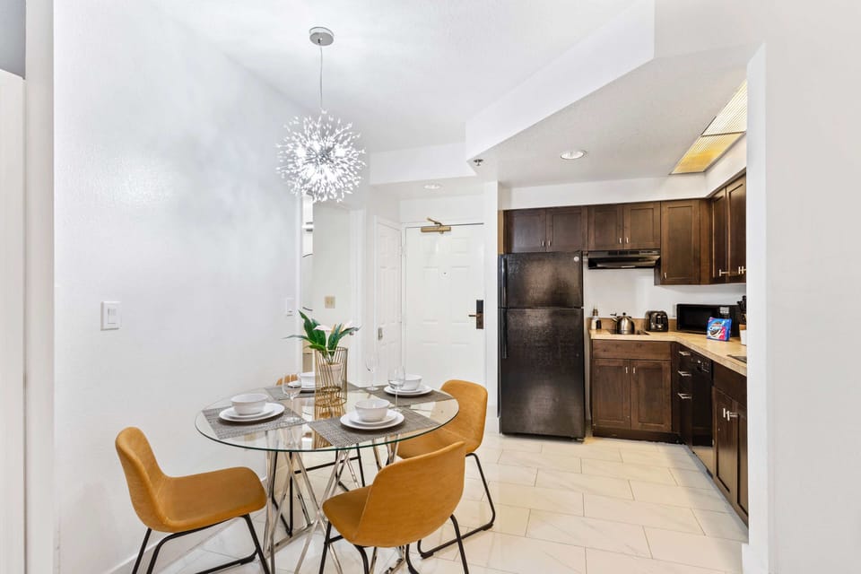 Living room with large smart TV, sleeper sofa and kitchen