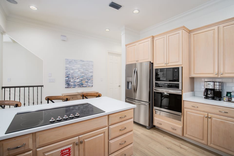 Your fully equipped kitchen features warm wood cabinets, stainless steel appliances, and everything you need to create memorable meals together.