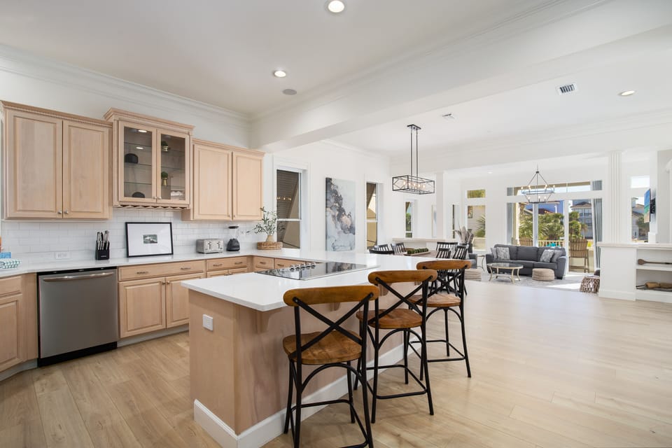 You'll love cooking in this spacious kitchen with gleaming countertops and island seating that flows seamlessly into the bright dining area.