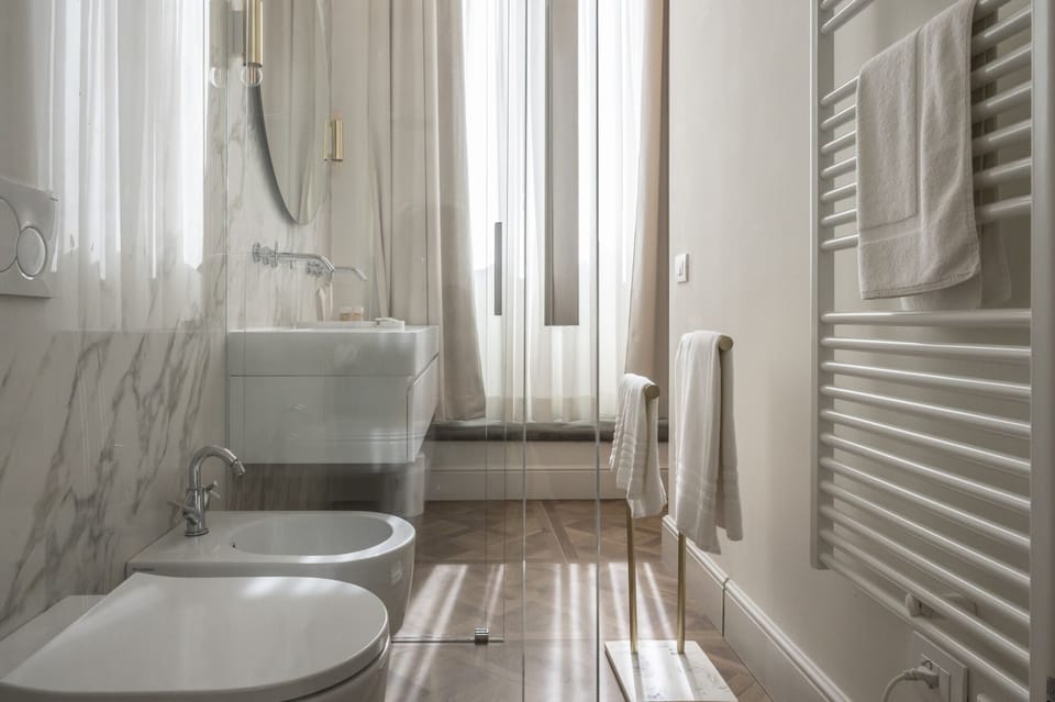 Deluxe Suite | Bathroom | Designer toiletries, hair dryer, bathrobes, slippers