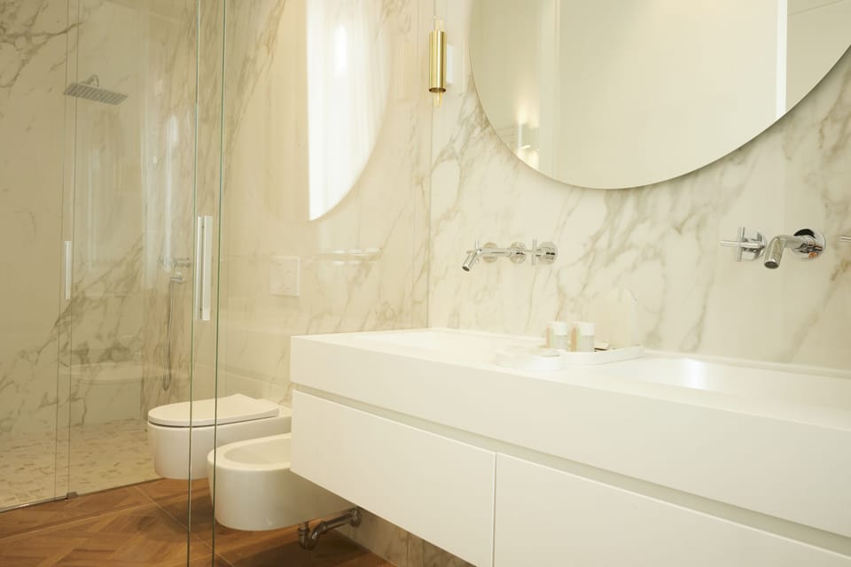 Deluxe Suite | Bathroom | Designer toiletries, hair dryer, bathrobes, slippers