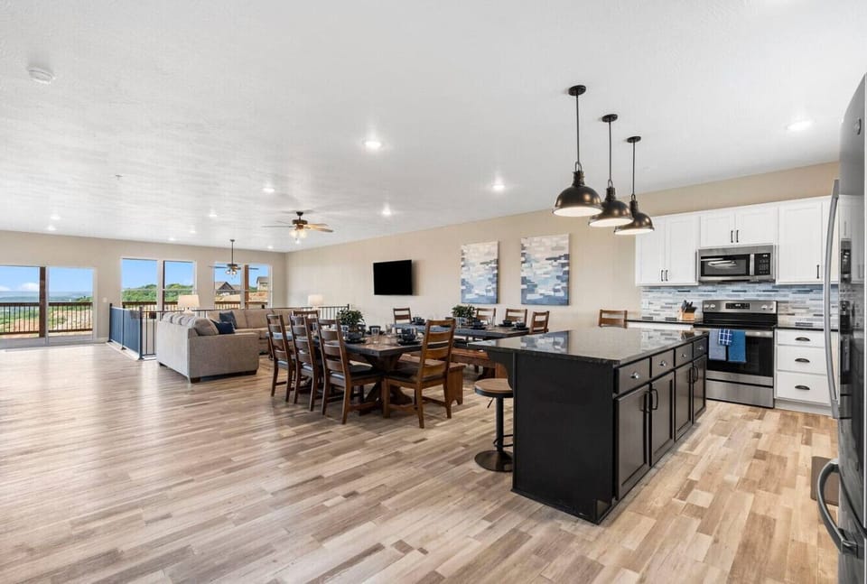 Open Kitchen to the dining and living area. Catwalk leads out to deck 1, and the expansive windows provide a great view while eating at the large dining tables.