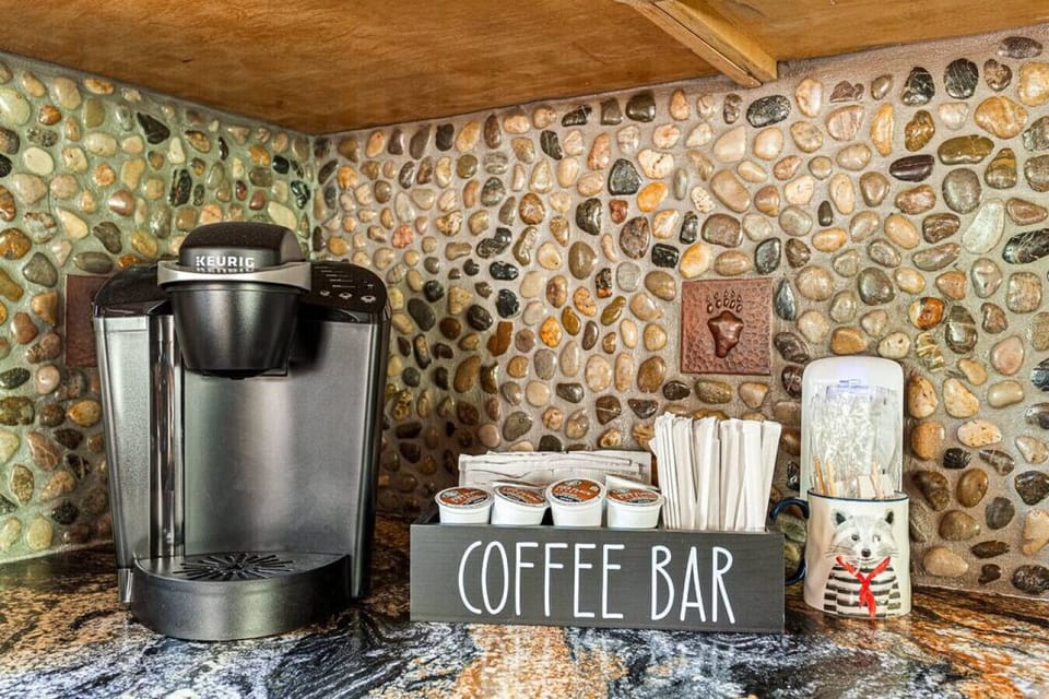 Keurig coffee maker with coffee, cream and sugar.