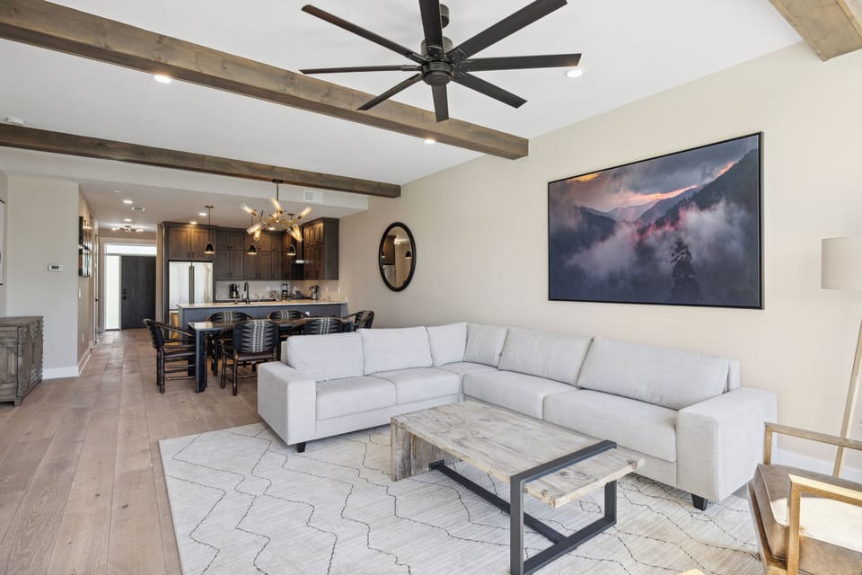 Spacious and Scenic Living Room with Stone Fireplace, Floor to Ceiling Windows with Smoky Mountain View, Smart TV's and WiFi throughout vacation condo