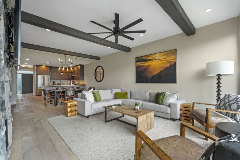 Spacious and Scenic Living Room with Stone Fireplace, Floor to Ceiling Windows with Smoky Mountain View, Smart TV's and WiFi throughout vacation condo