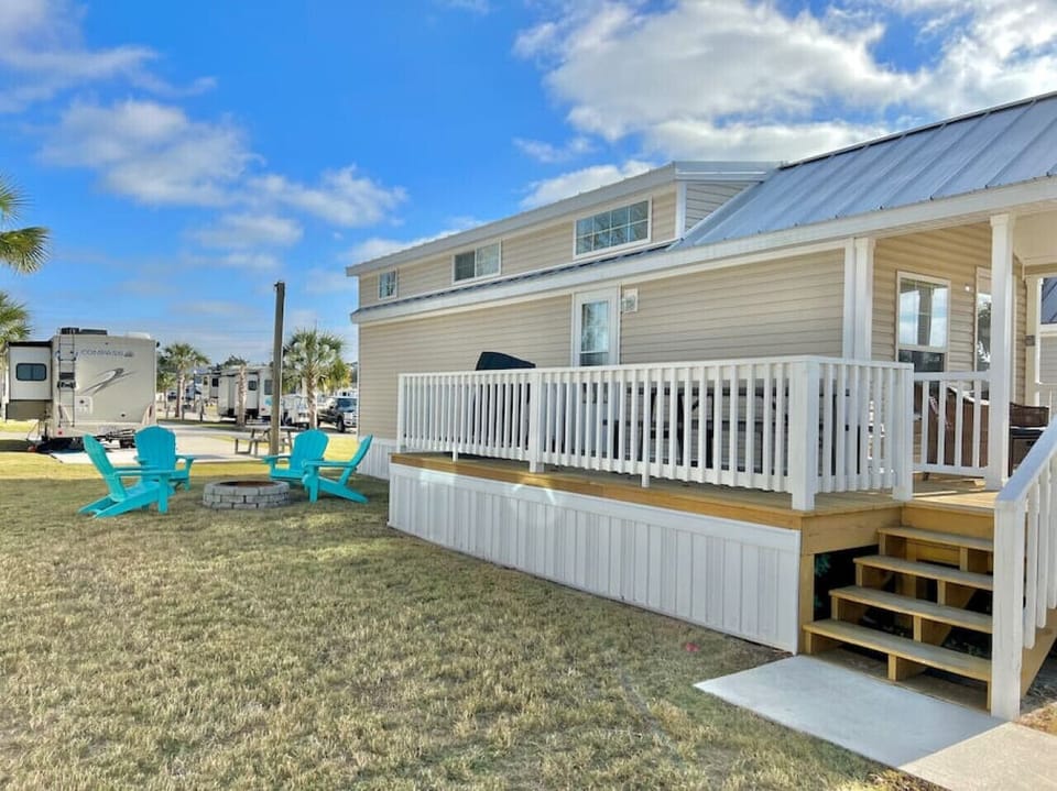 Spacious private side yard with fire pit and chairs. Firewood and ice are available for purchase at the resort.
