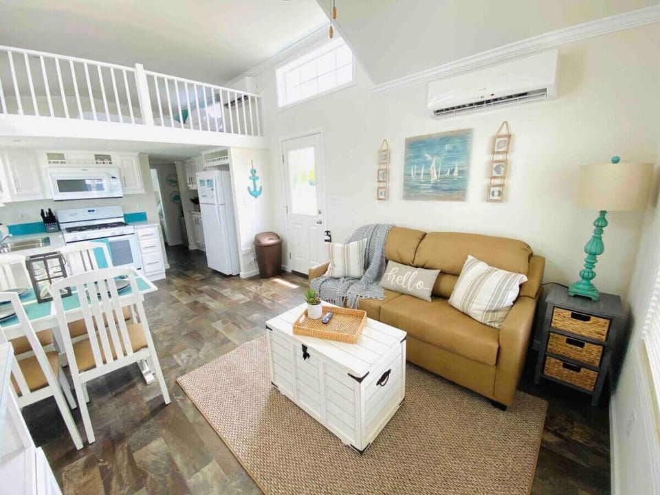 Main living room area with sofa sleeper and view of the loft above.