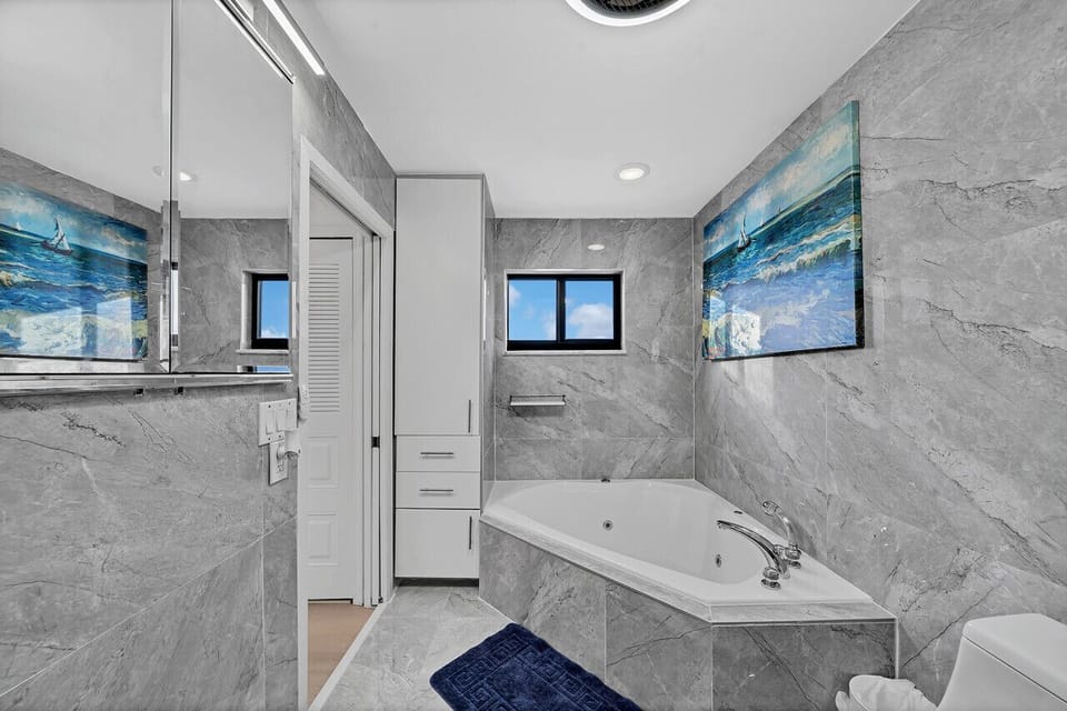 Gorgeous marble-tiled ensuite bathroom w jacuzzi tub