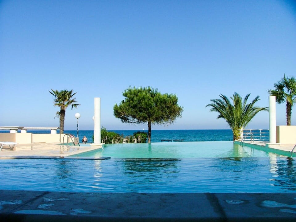 Water, Sky, Blue, Swimming Pool, Tree, Arecales, Plant, Shade, Outdoor Furniture, Leisure