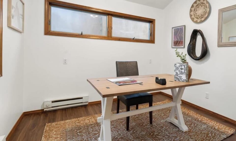 "Minimalist Home Office Design with Stylish Wooden Desk and Eclectic Wall Decor"