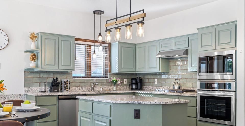 "Elegant Modern Kitchen Design with Stylish Duck Egg Blue Cabinetry and Sleek Stainless Steel Appliances - Perfect Blend of Function and Aesthetics for Your Dream Home"