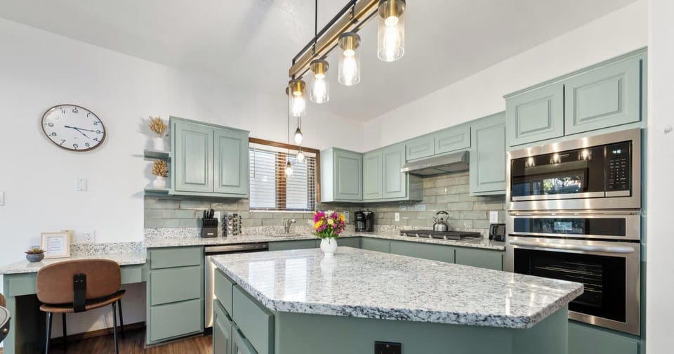 "Chic Modern Kitchen with Mint Green Cabinets and Granite Countertops - Perfect Blend of Style and Functionality"